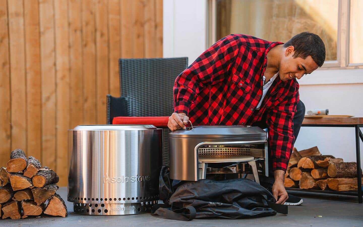 A person unwrapping a pizza oven designed to work on grill. A person unwrapping a pizza oven designed to work on grill.