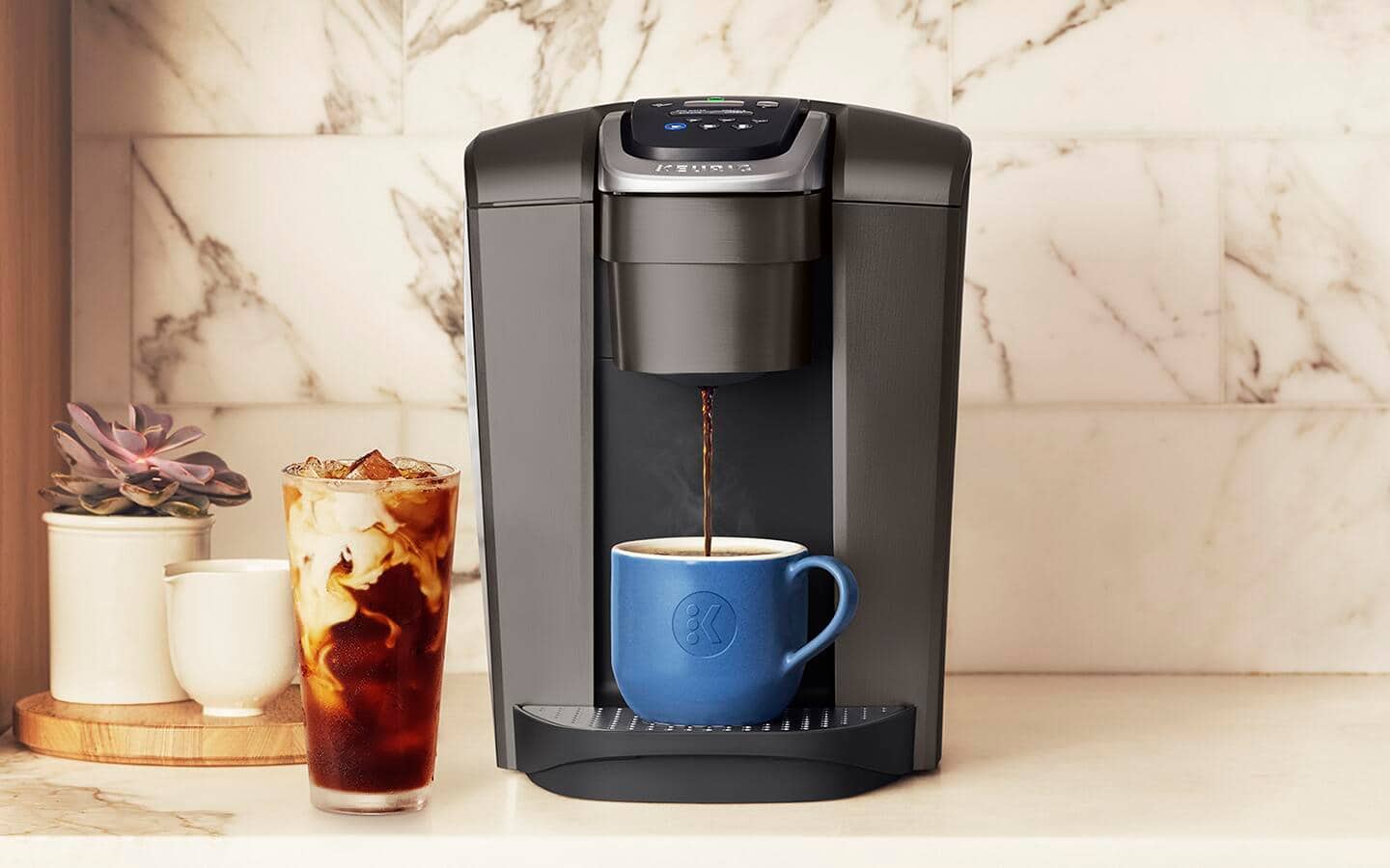 A cup of coffee being made from a single serve coffee maker.