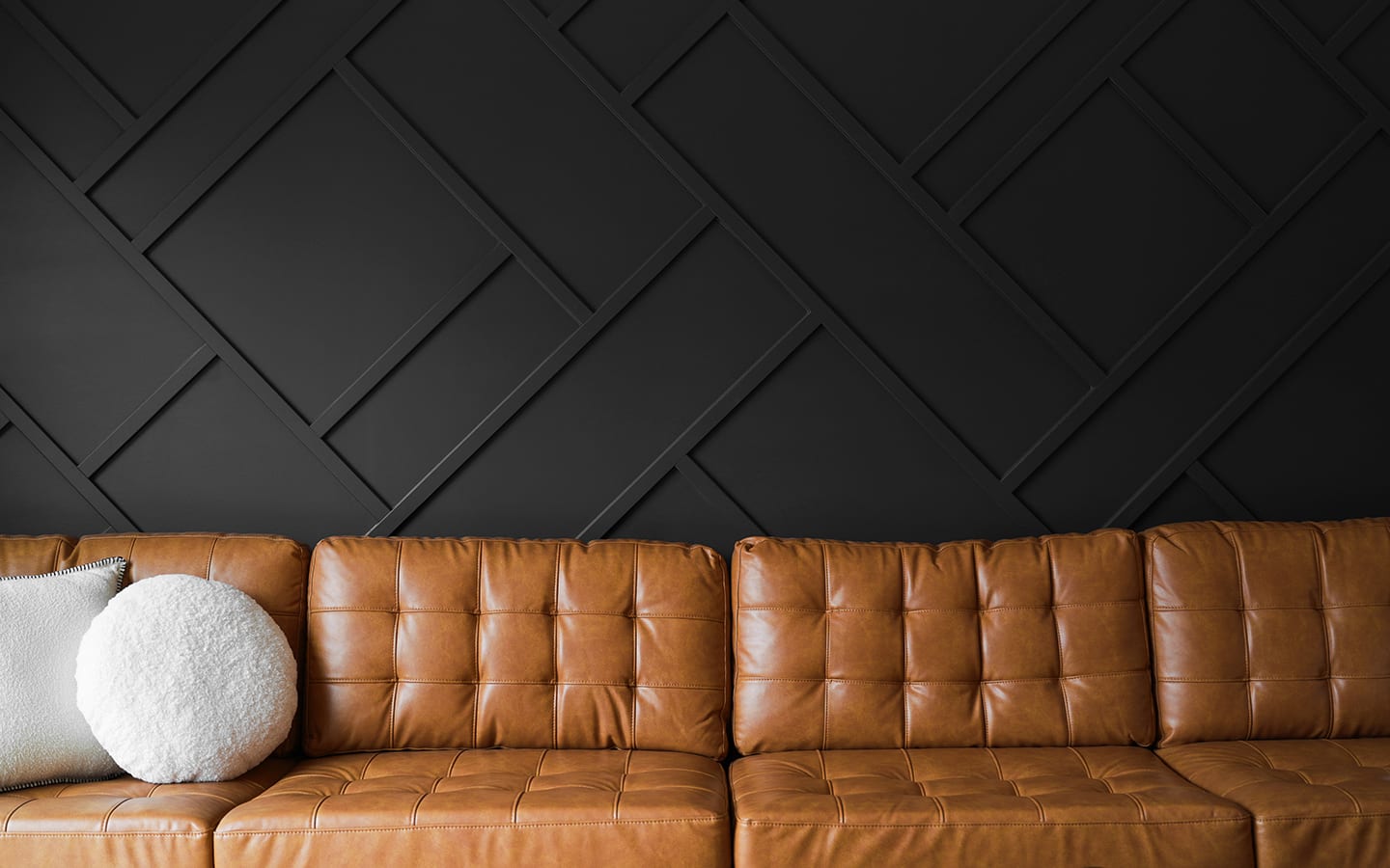 A dark brown accent wall with rectangular picture frame moulding patterns. A dark brown accent wall with rectangular picture frame moulding patterns.