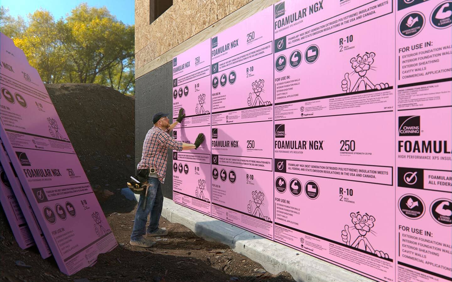 A man installs foam board insulation. A man installs foam board insulation.