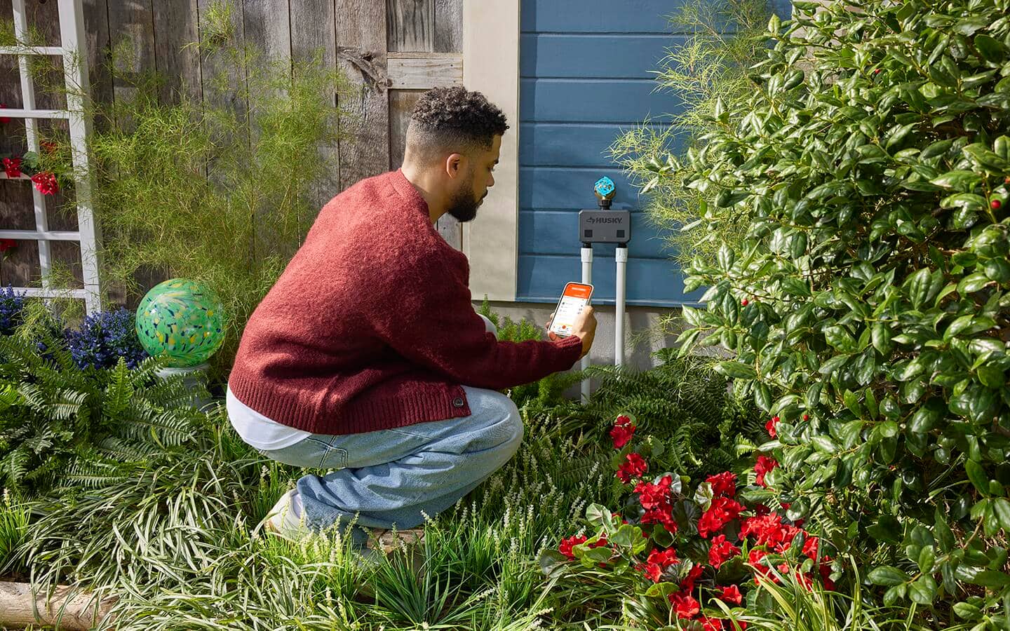 Someone checking a smart irrigation system installed at a home. Someone checking a smart irrigation system installed at a home.