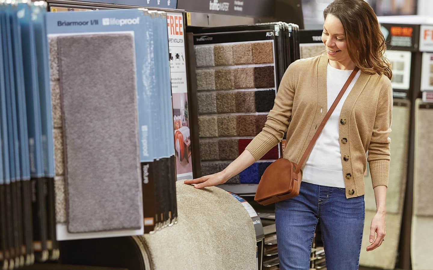 A Home Depot customer comparing carpet samples.