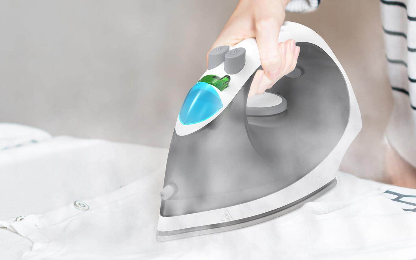 A person using an iron as a steamer. A person using an iron as a steamer.
