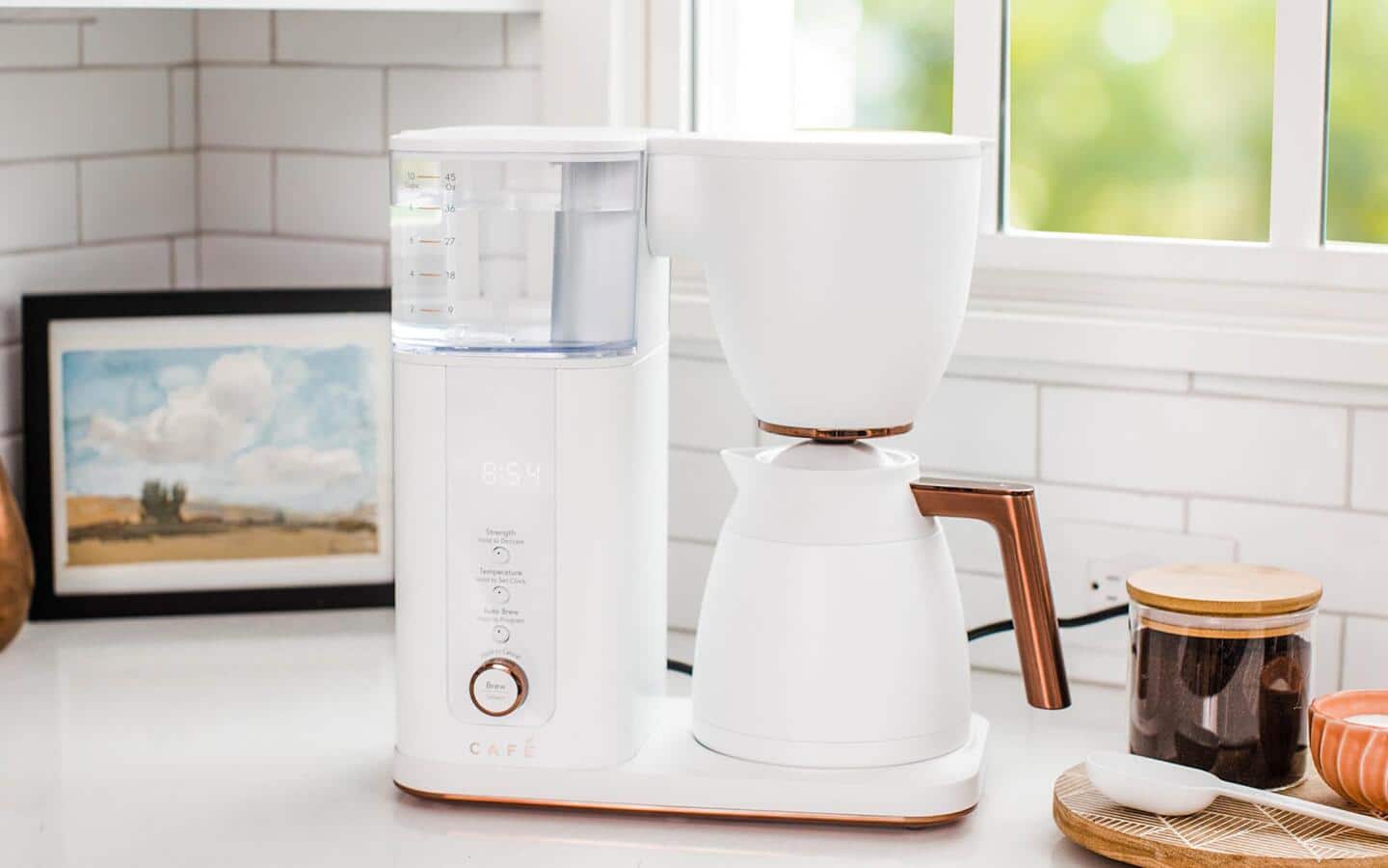 A white automatic coffee maker on a kitchen counter.