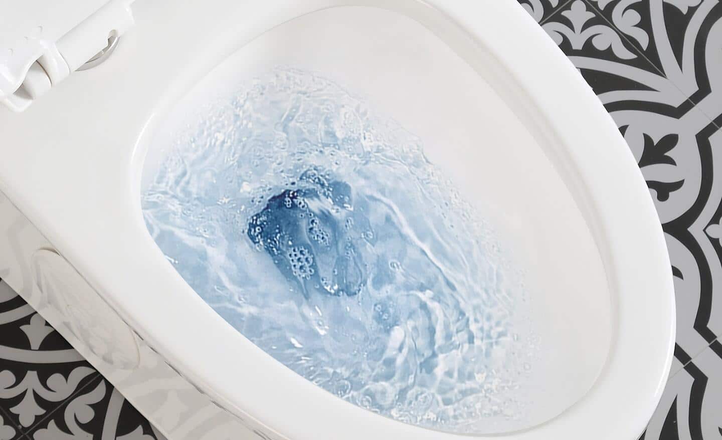 A toilet flushing blue water.