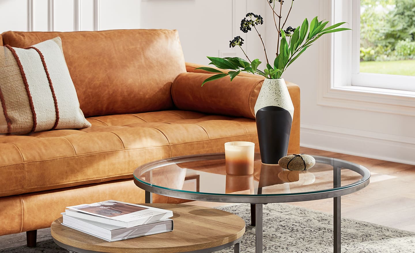 Glass coffee table with objects in a living room