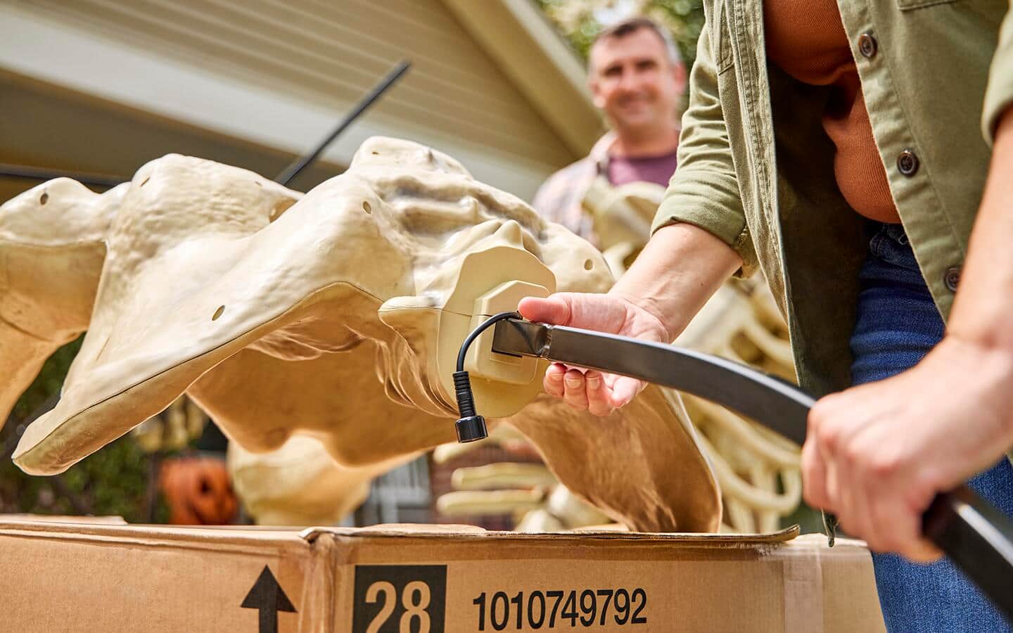 A person attaches the metal piece for the backbone’s support. A person attaches the metal piece for the backbone’s support.
