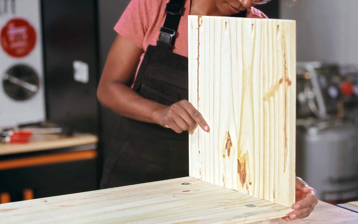 Two pieces of wood being lined up to assemble a shoe rack's side boards. Two pieces of wood being lined up to assemble a shoe rack's side boards.