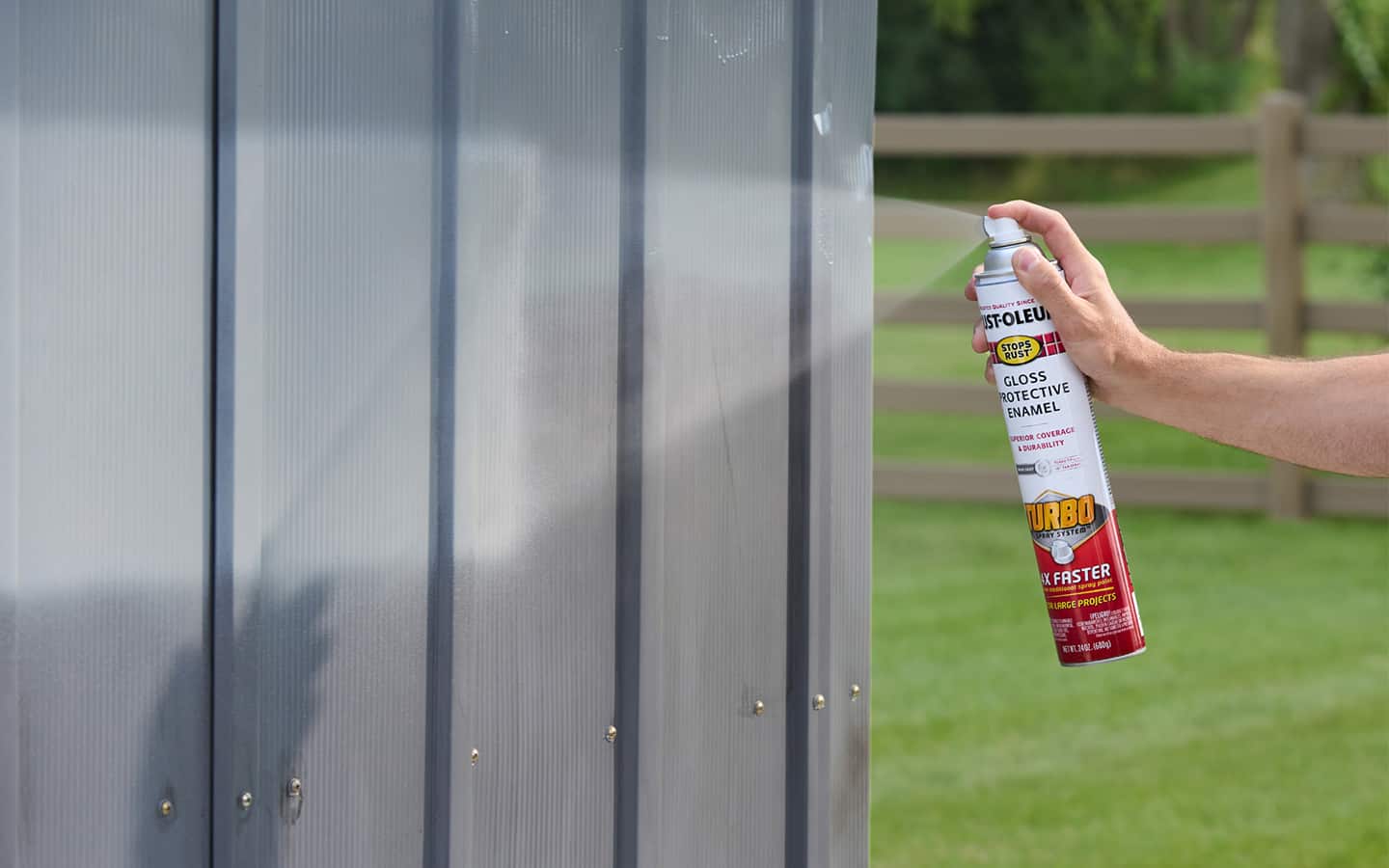 A person applying a coat of spray paint.