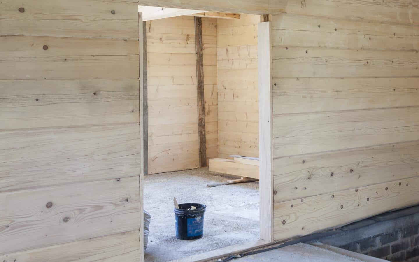 An empty frame for a new bifold door in a wooden wall. An empty frame for a new bifold door in a wooden wall.