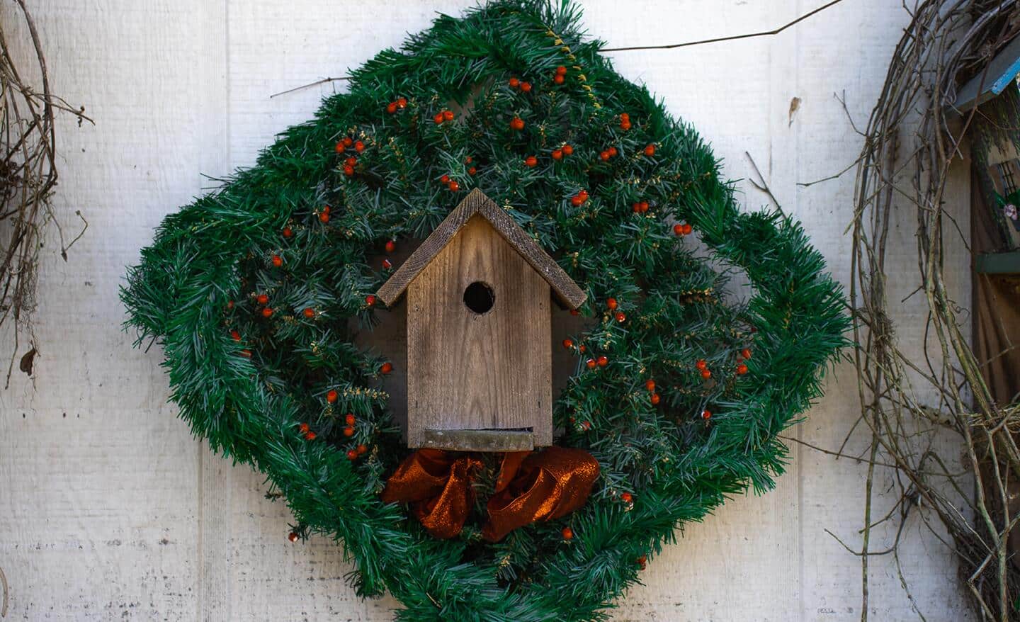 A birdhouse wreath hanging up. A birdhouse wreath hanging up.