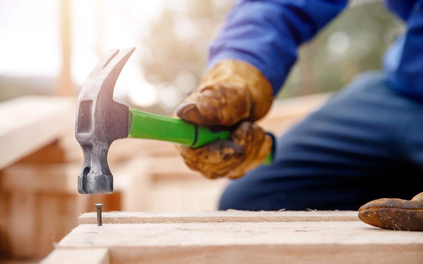 A person nails a stud with a hammer. A person nails a stud with a hammer.