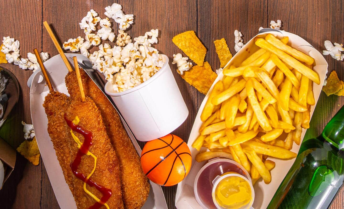 Basketball-inspired food spread of corn dogs, popcorn, fries and more.