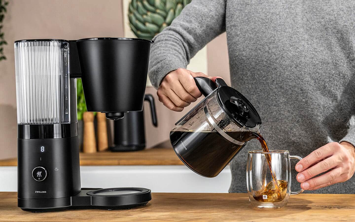 Person pours coffee into a cup