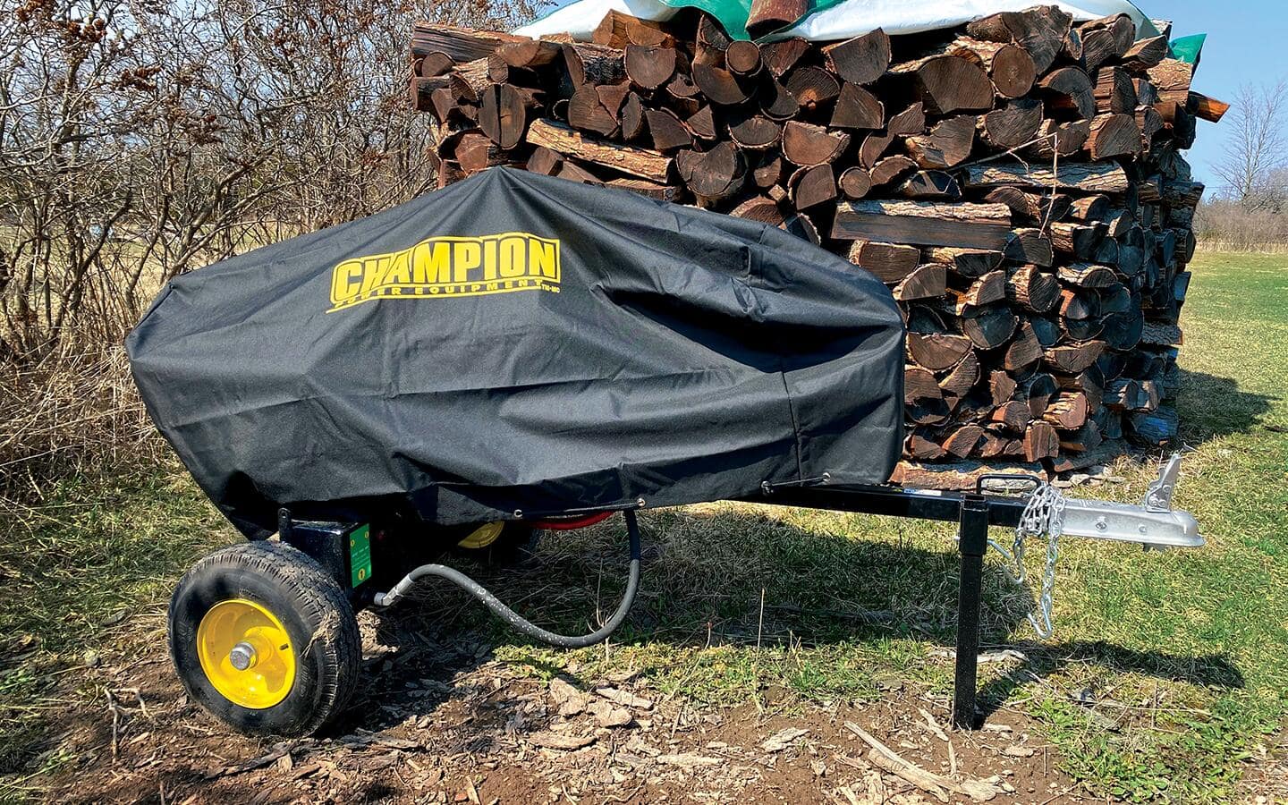A log splitter being stored outside with a cover A log splitter being stored outside with a cover