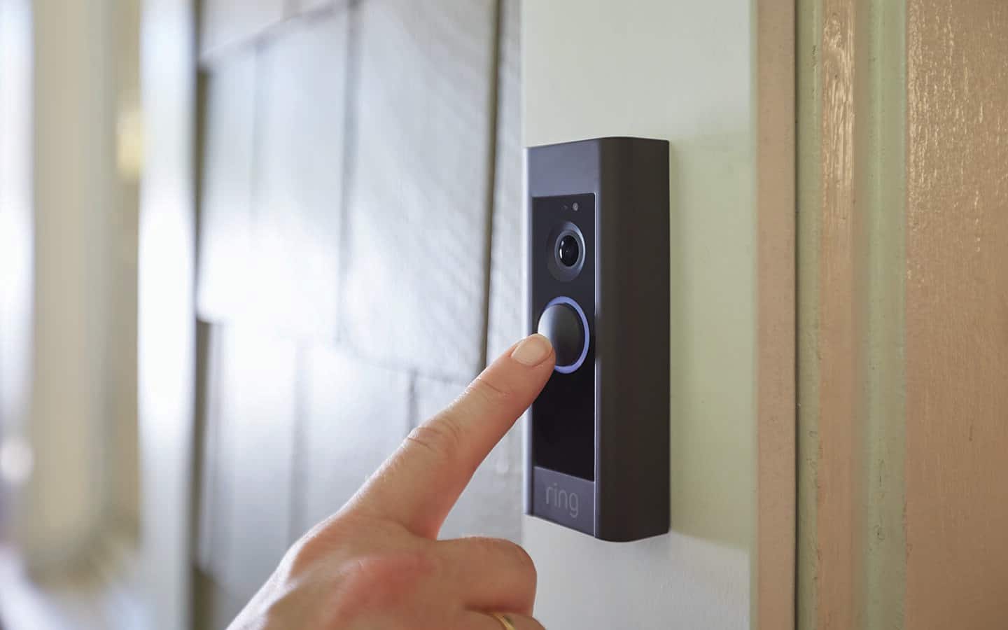 Someone using a video doorbell. Someone using a video doorbell.