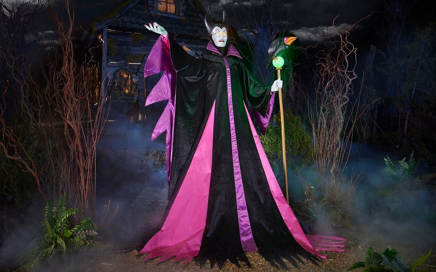 Yard decor of Maleficent, the Evil Queen in an outdoor Halloween scene.