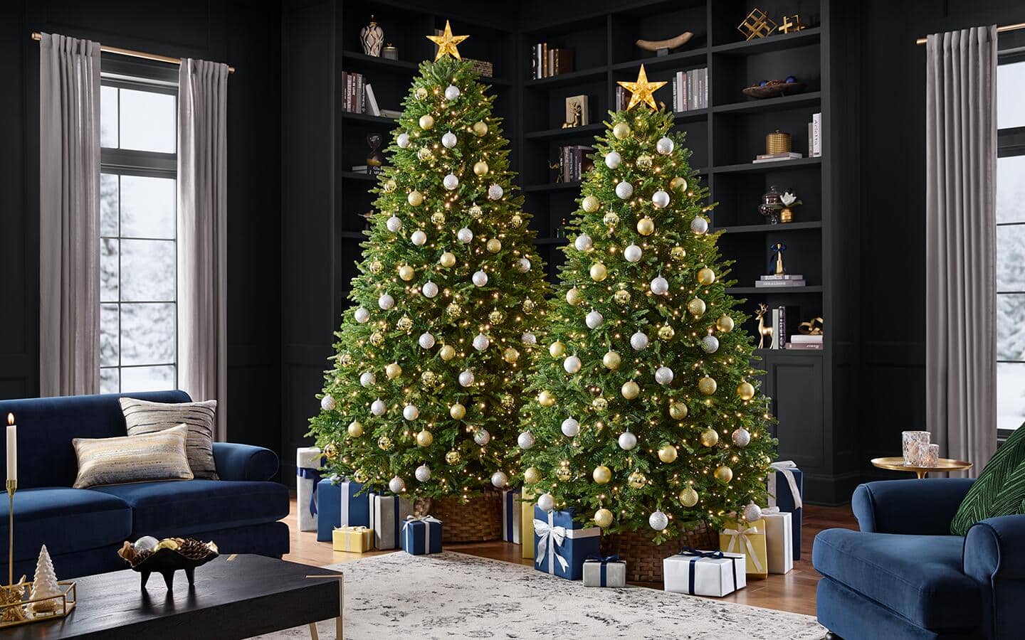 Two decorated artificial balsam fir Christmas trees in a holiday living room.