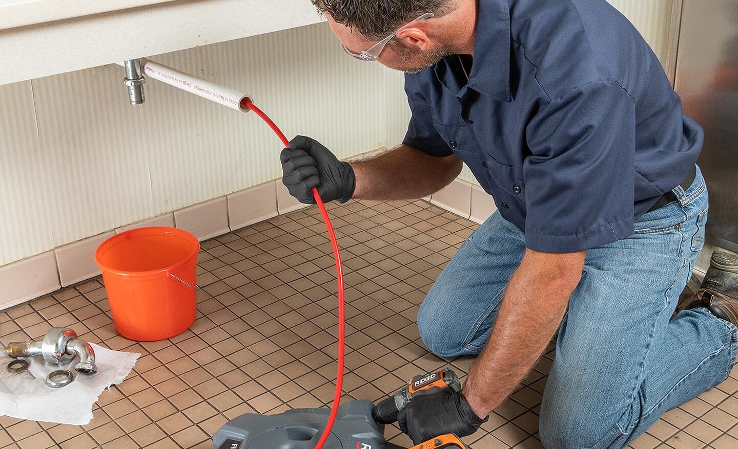 A man uses an inspection camera to check a drain line.