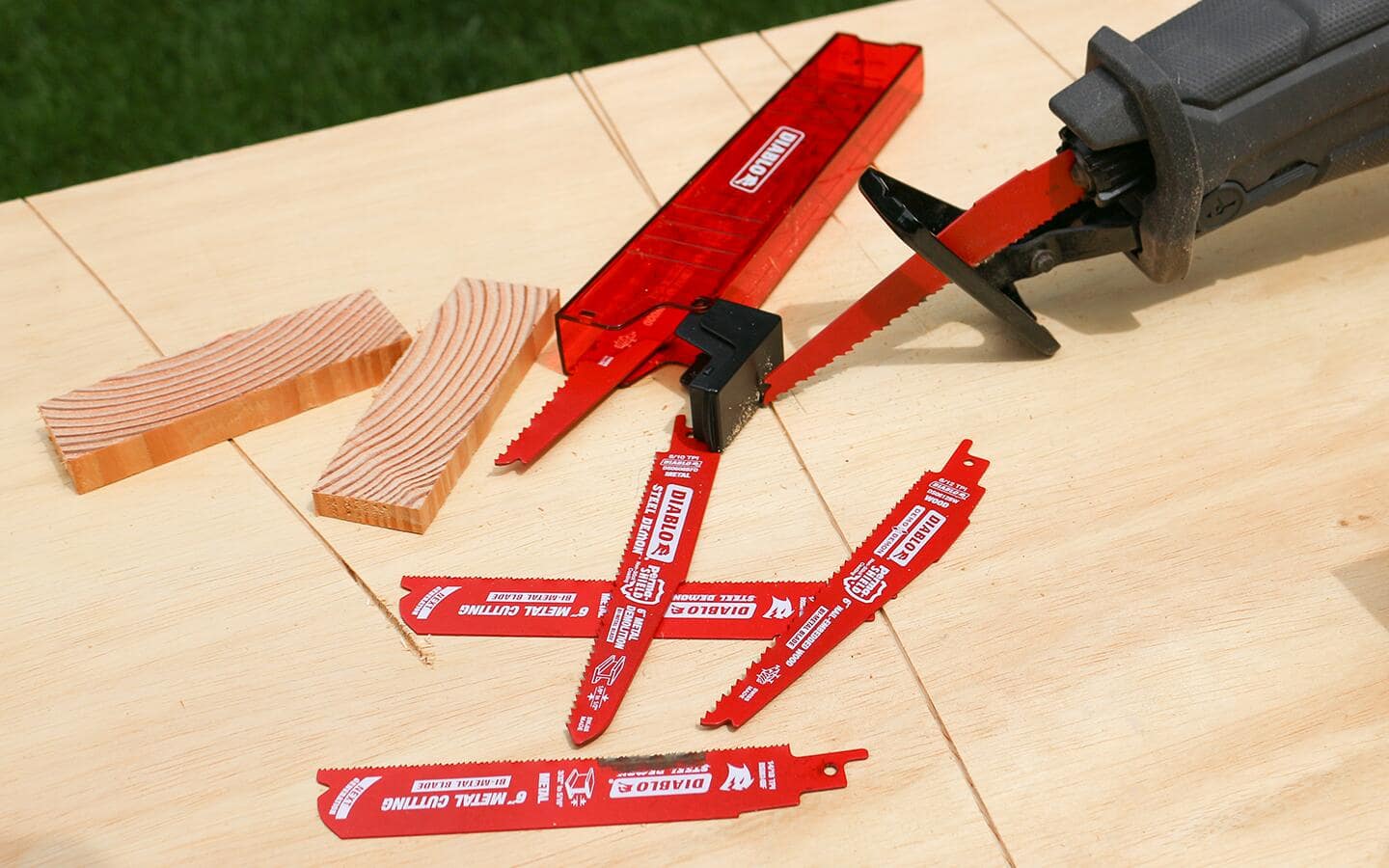 A set of red reciprocating saw blades for cutting different types of material.