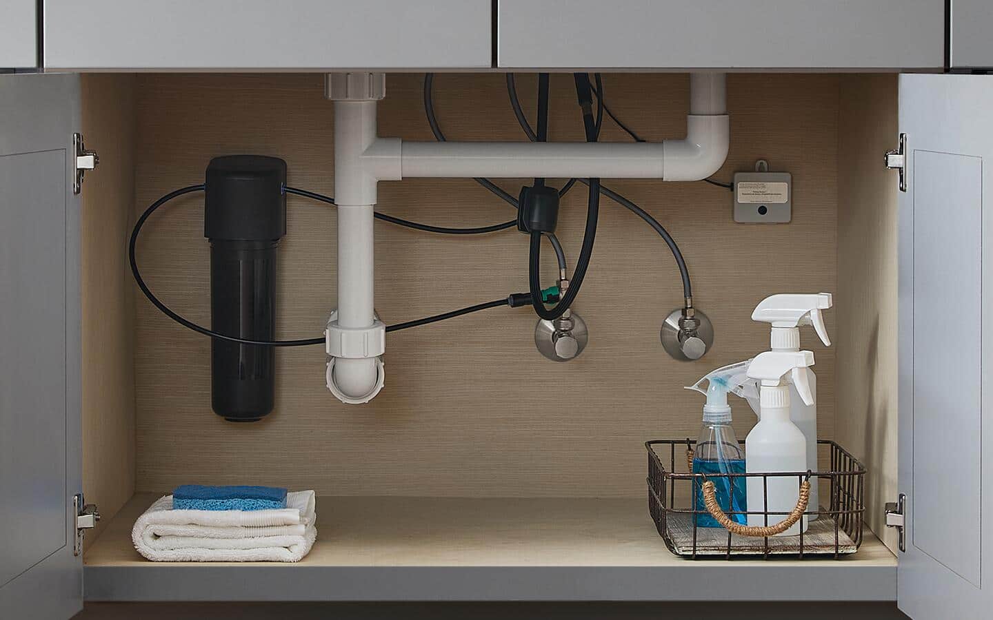 A black supply line attached to a sink. A black supply line attached to a sink.