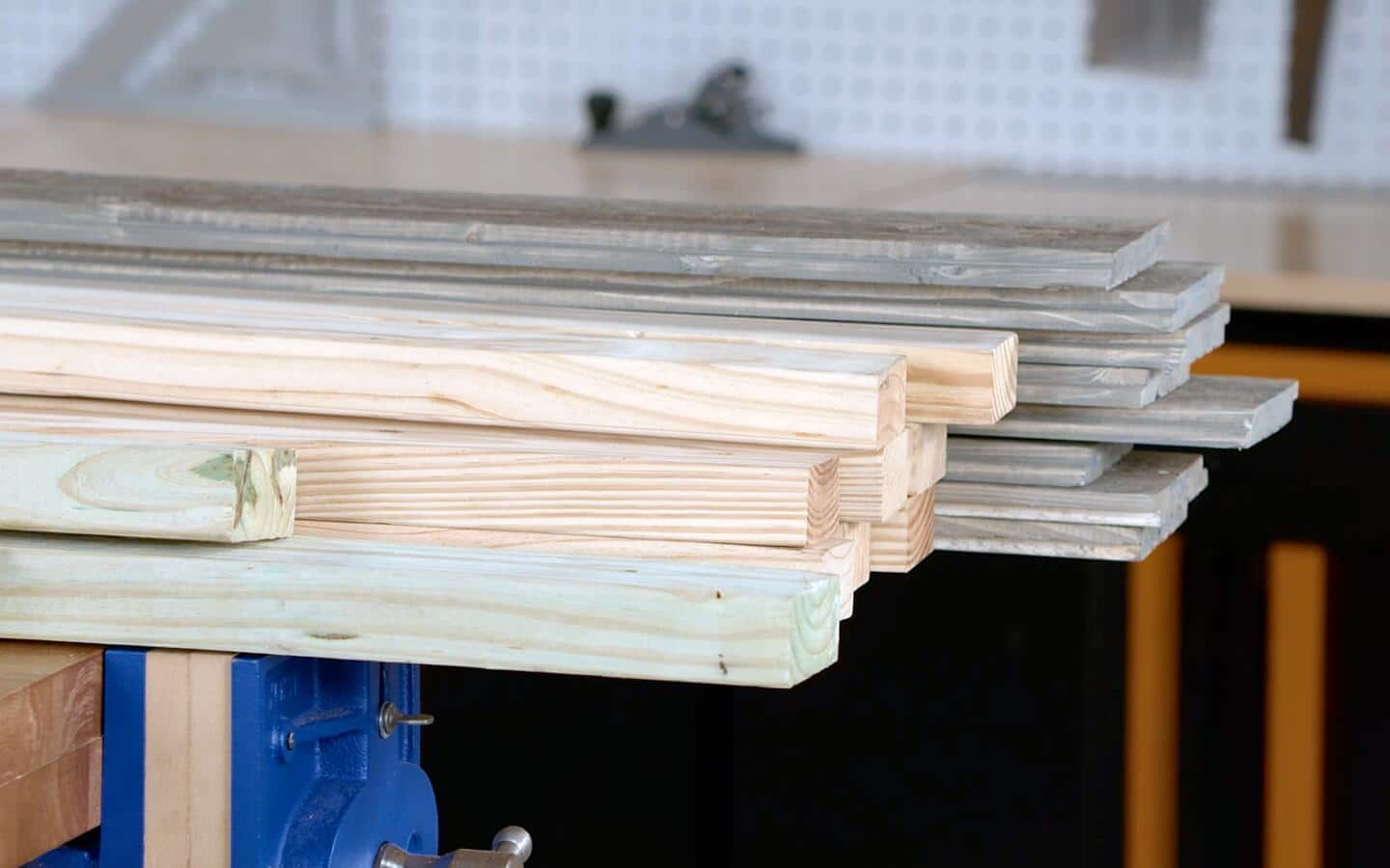 Wooden boards of various sizes used to make a dog house.