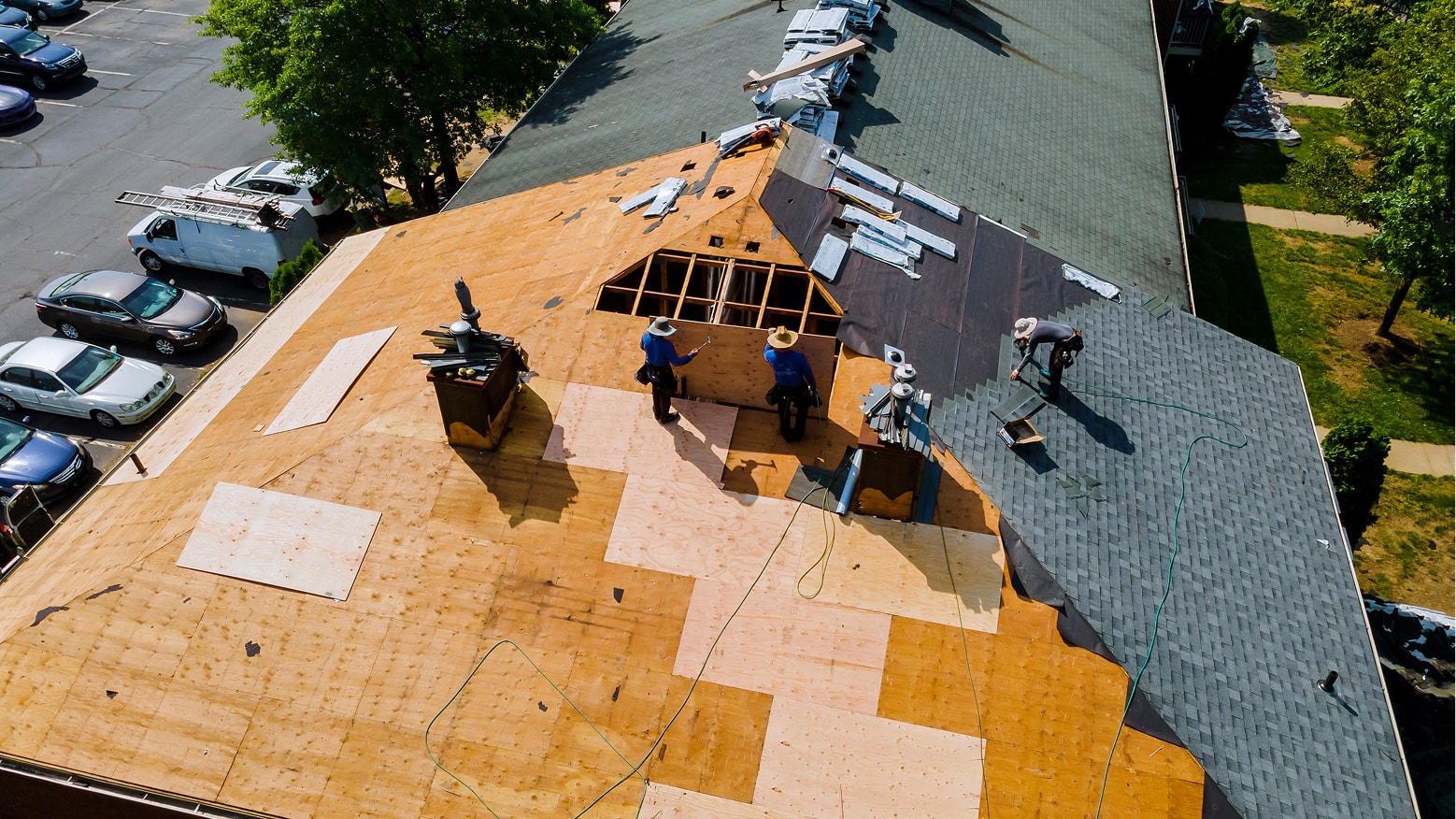 A roofing Pro installs shingles on a new house.
