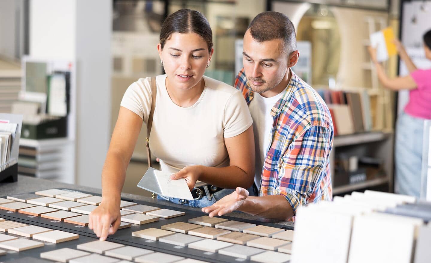 A couple selecting tile samples. A couple selecting tile samples.