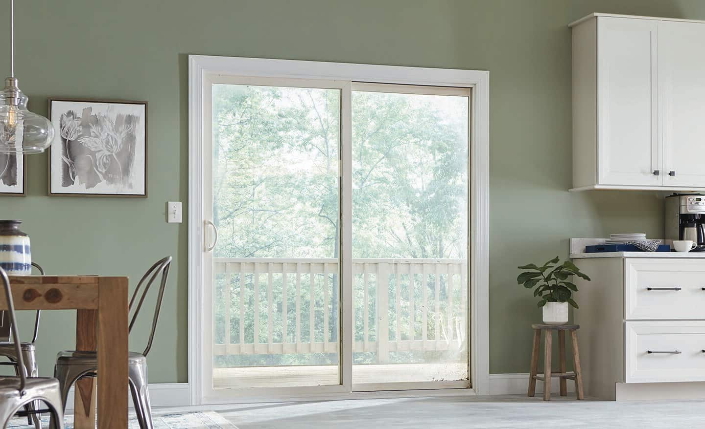 A white sliding door leads from the dining room to the deck.