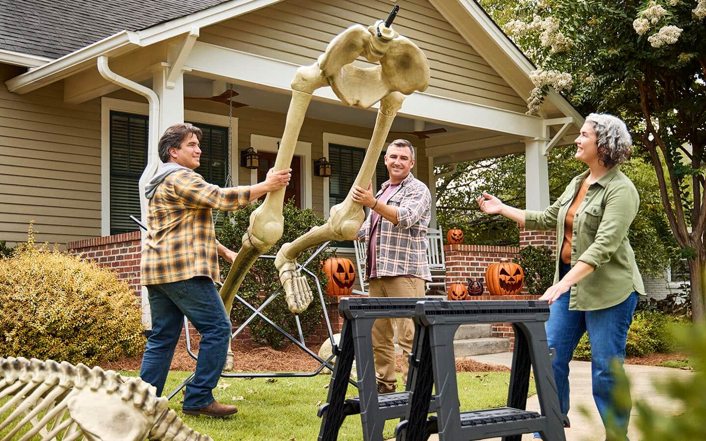 Three people work together to lay the partially completed skeleton onto a sawhorse. Three people work together to lay the partially completed skeleton onto a sawhorse.