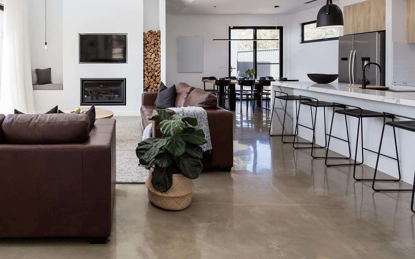 A living room featuring a polished concrete floor.