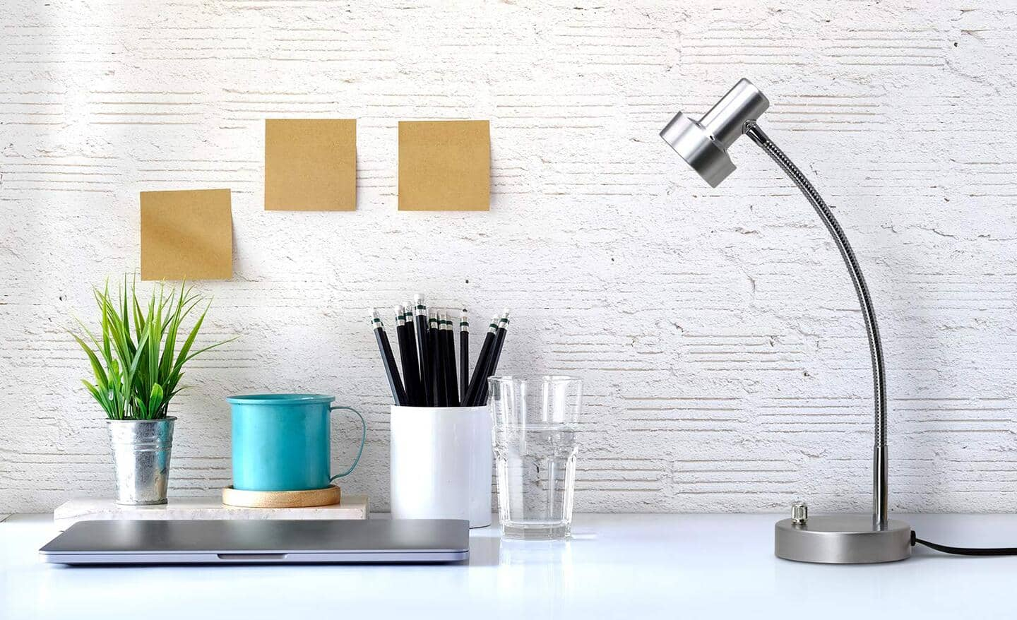 A gooseneck desk lamp on a home office desk. 