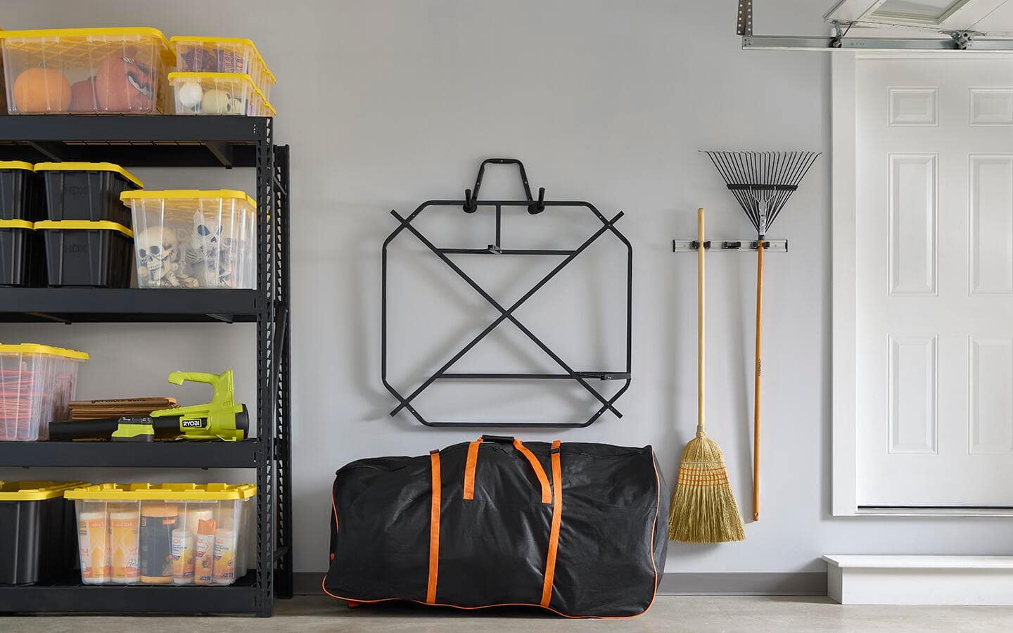 A storage bag is in a garage with the Skelly base hung neatly on the wall. A storage bag is in a garage with the Skelly base hung neatly on the wall.