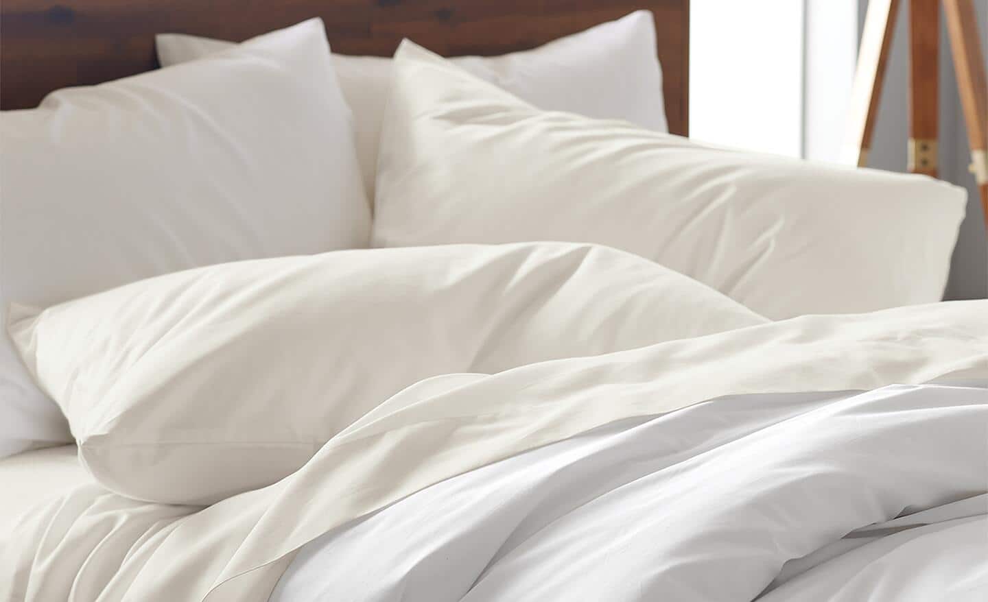 Pillows and other bedding stacked on a bed. Pillows and other bedding stacked on a bed.