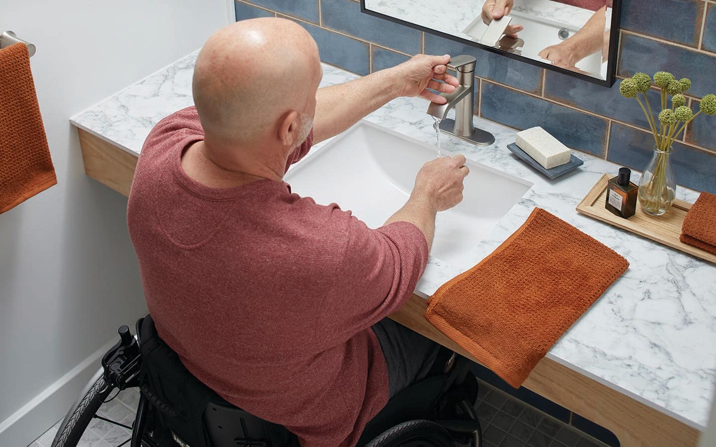 A man uses a single lever faucet to wash his hands. A man uses a single lever faucet to wash his hands.
