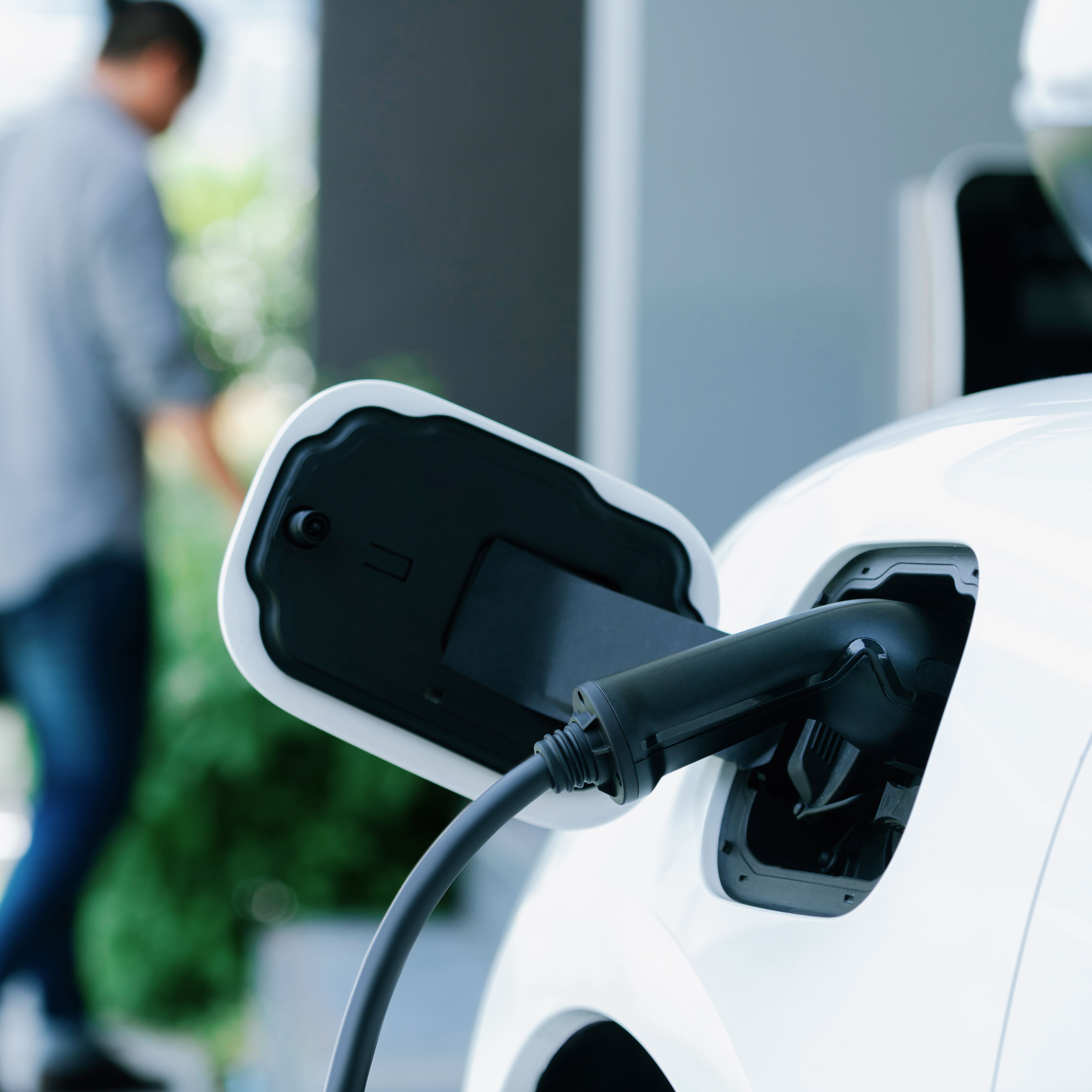 An electric vehicle plugged into an EV charger.