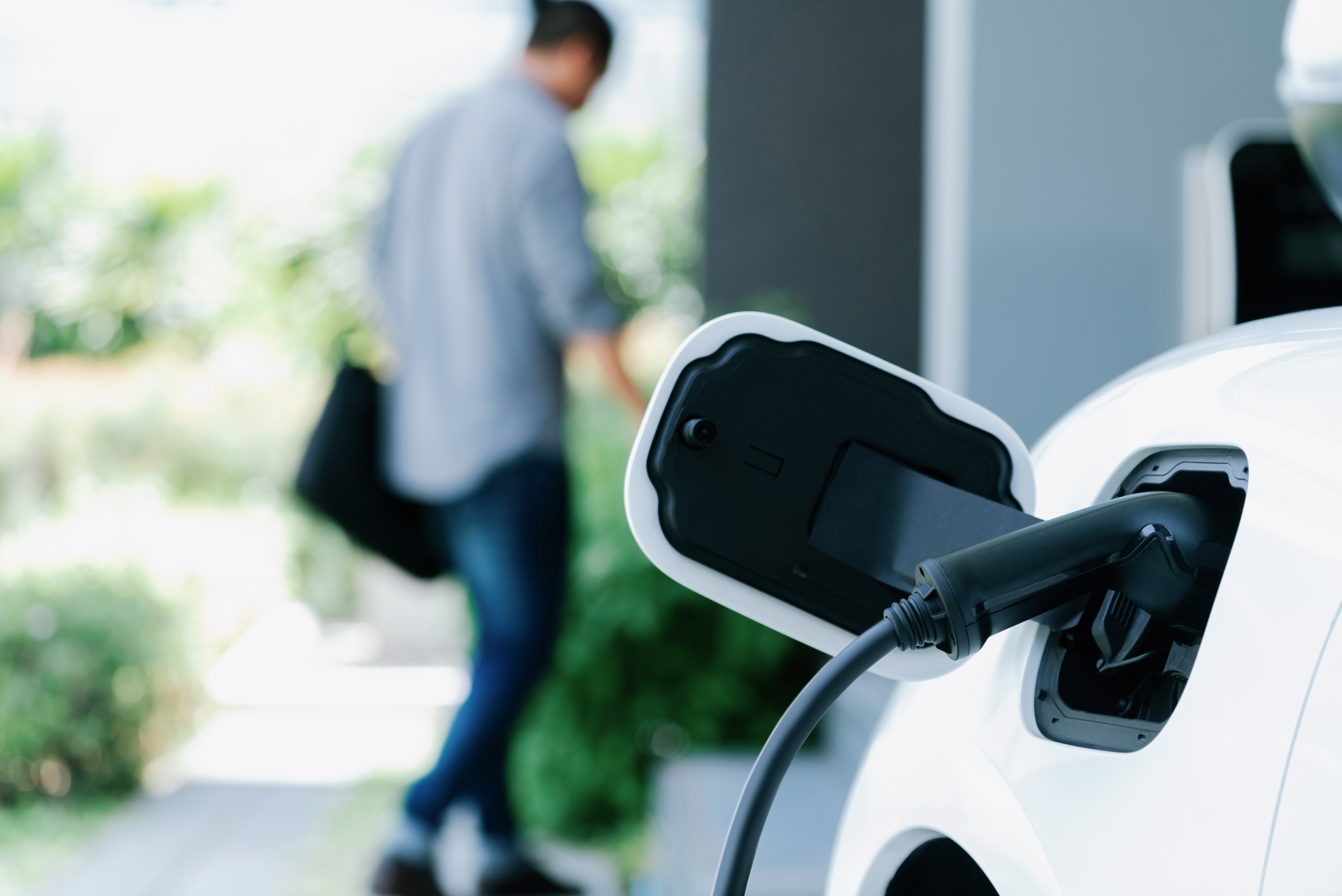 An electric vehicle plugged into an EV charger.